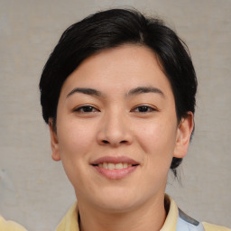 Joyful asian young-adult female with medium  black hair and brown eyes