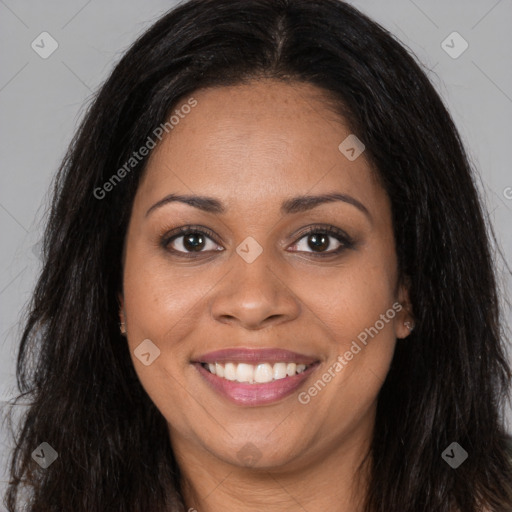 Joyful black young-adult female with long  brown hair and brown eyes