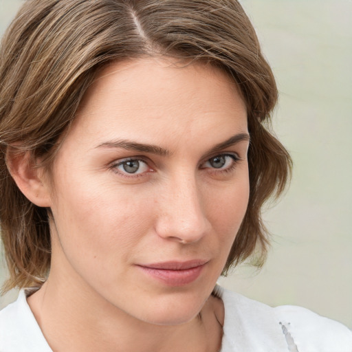 Joyful white young-adult female with medium  brown hair and blue eyes