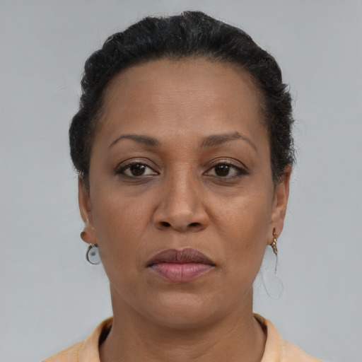 Joyful latino adult female with short  brown hair and brown eyes