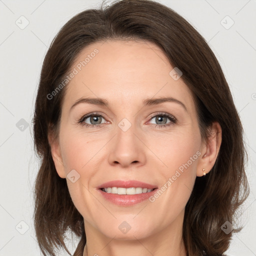 Joyful white adult female with medium  brown hair and grey eyes