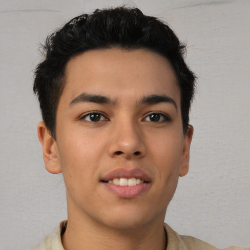 Joyful latino young-adult male with short  brown hair and brown eyes