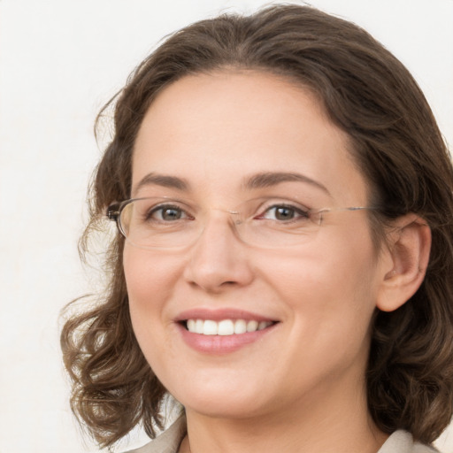 Joyful white adult female with medium  brown hair and green eyes