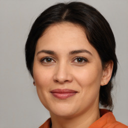 Joyful white adult female with medium  brown hair and brown eyes