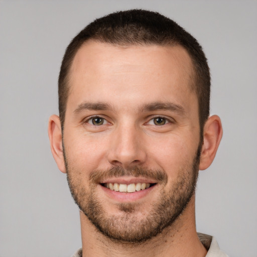 Joyful white young-adult male with short  brown hair and brown eyes