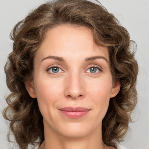 Joyful white young-adult female with medium  brown hair and green eyes