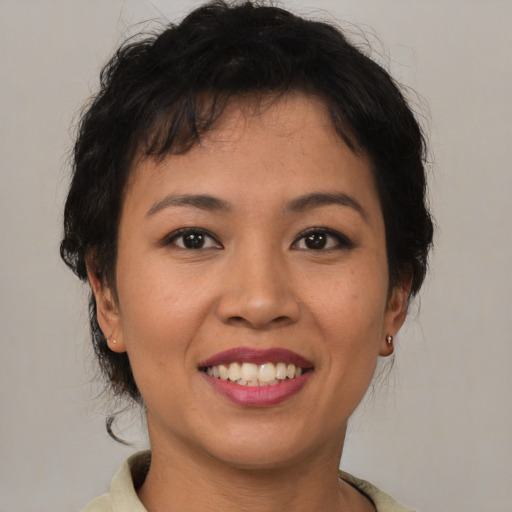 Joyful asian young-adult female with short  brown hair and brown eyes