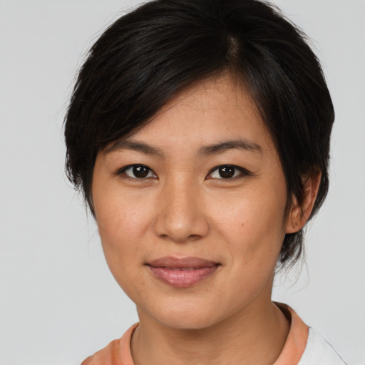 Joyful asian young-adult female with medium  brown hair and brown eyes