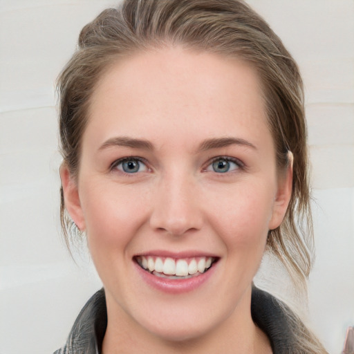 Joyful white young-adult female with medium  brown hair and blue eyes