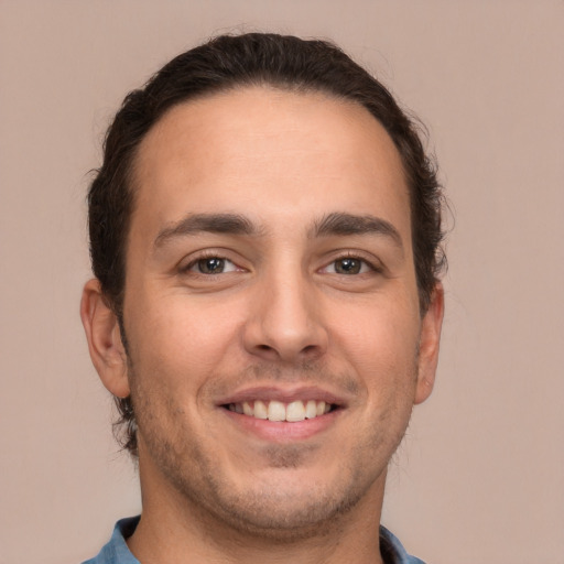 Joyful white young-adult male with short  brown hair and brown eyes