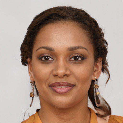 Joyful black young-adult female with medium  brown hair and brown eyes