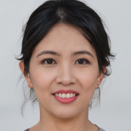 Joyful asian young-adult female with medium  brown hair and brown eyes