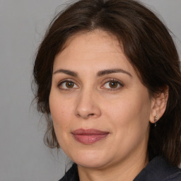 Joyful white adult female with medium  brown hair and brown eyes