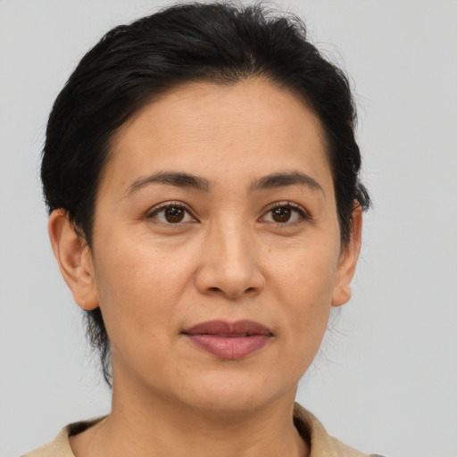 Joyful asian adult female with short  brown hair and brown eyes