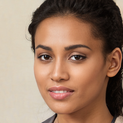 Joyful latino young-adult female with long  brown hair and brown eyes