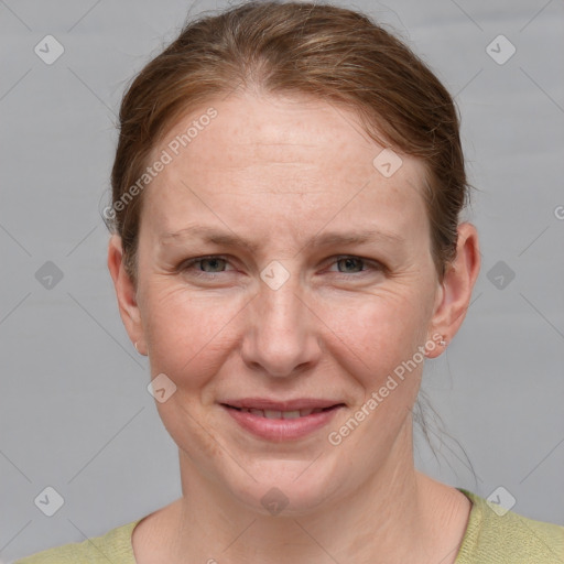 Joyful white adult female with short  brown hair and blue eyes