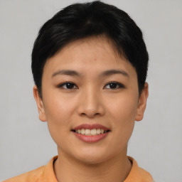 Joyful asian young-adult female with short  brown hair and brown eyes