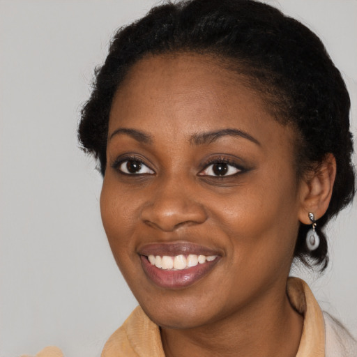 Joyful black adult female with short  brown hair and brown eyes