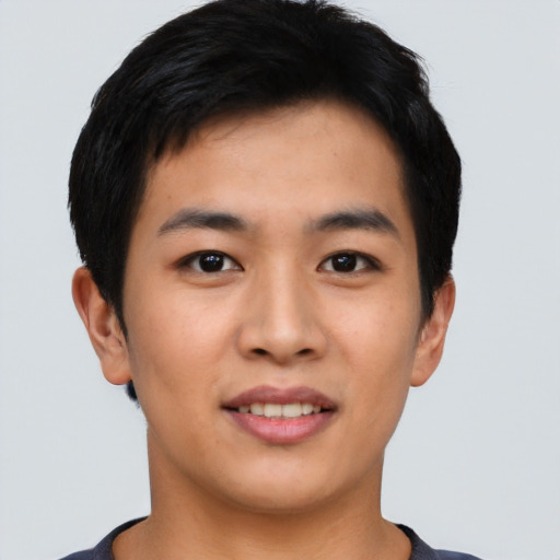 Joyful asian young-adult male with short  black hair and brown eyes