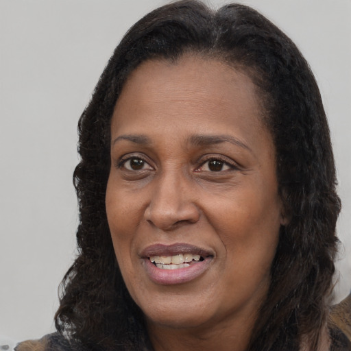 Joyful latino adult female with long  brown hair and brown eyes