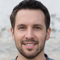 Joyful white young-adult male with short  brown hair and brown eyes