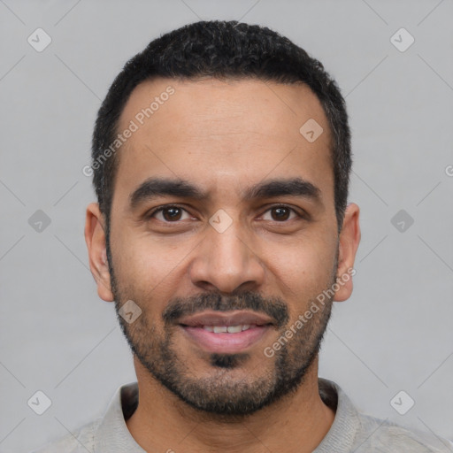Joyful latino young-adult male with short  black hair and brown eyes