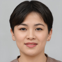 Joyful asian young-adult female with short  brown hair and brown eyes