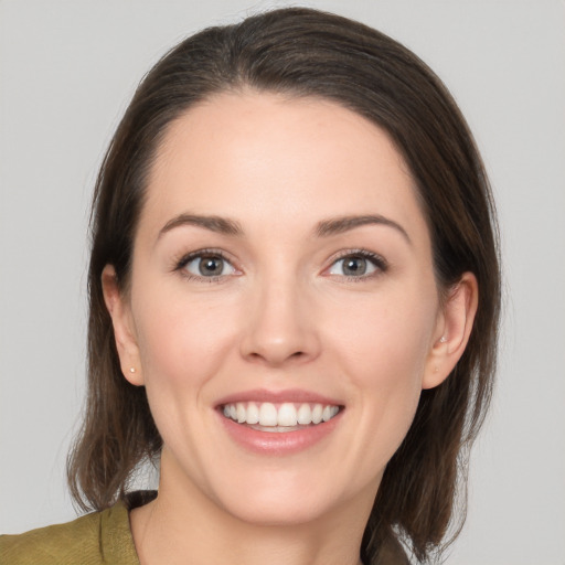 Joyful white young-adult female with medium  brown hair and brown eyes