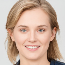 Joyful white young-adult female with medium  brown hair and blue eyes