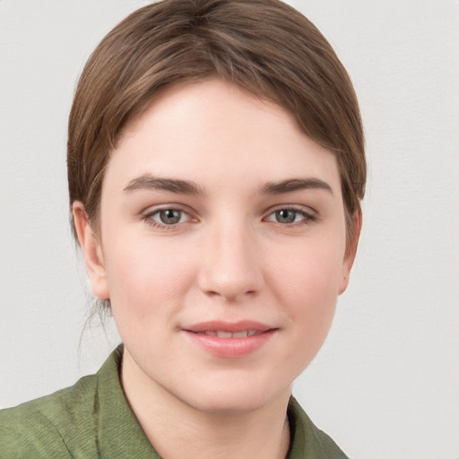 Joyful white young-adult female with short  brown hair and grey eyes