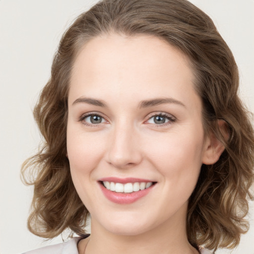 Joyful white young-adult female with medium  brown hair and green eyes