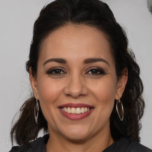 Joyful white adult female with long  brown hair and brown eyes