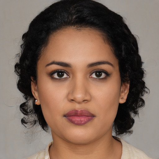 Joyful latino young-adult female with medium  black hair and brown eyes
