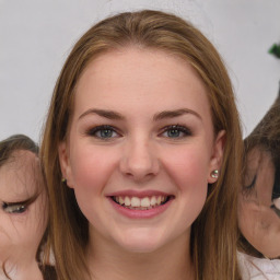 Joyful white young-adult female with medium  brown hair and green eyes