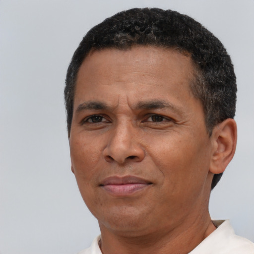 Joyful black adult male with short  brown hair and brown eyes