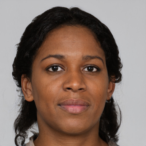 Joyful black adult female with medium  black hair and brown eyes