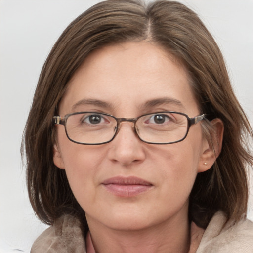 Joyful white adult female with medium  brown hair and grey eyes