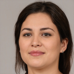 Joyful white young-adult female with medium  brown hair and brown eyes