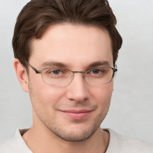 Joyful white young-adult male with short  brown hair and grey eyes