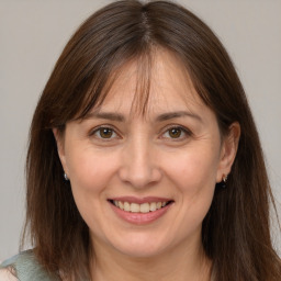 Joyful white adult female with medium  brown hair and brown eyes