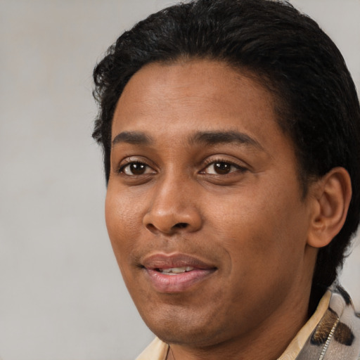 Joyful black young-adult male with short  black hair and brown eyes
