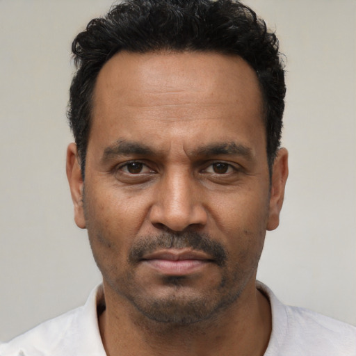 Neutral latino adult male with short  black hair and brown eyes