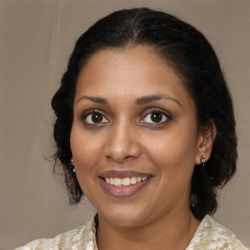 Joyful black young-adult female with medium  brown hair and brown eyes