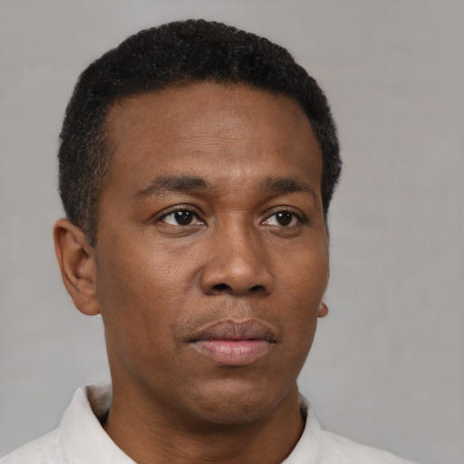 Neutral black adult male with short  brown hair and brown eyes