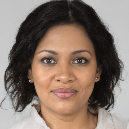 Joyful black adult female with medium  brown hair and brown eyes