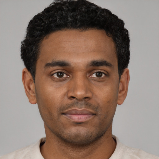 Neutral black young-adult male with short  black hair and brown eyes