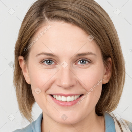 Joyful white young-adult female with medium  brown hair and blue eyes