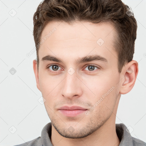 Neutral white young-adult male with short  brown hair and grey eyes