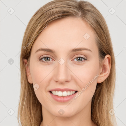 Joyful white young-adult female with long  brown hair and green eyes