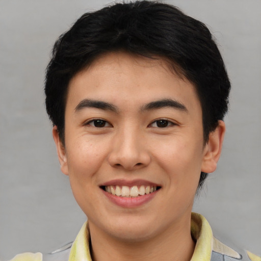 Joyful asian young-adult female with short  brown hair and brown eyes